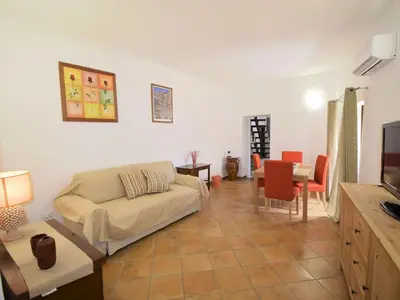 a living room with a couch and a table at Vecchio Cortile Home Holidays in Palermo