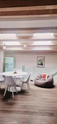 a room with a white table and chairs and a table and a couch at 2 Sicilie Rooms and Suite in Centro in Palermo