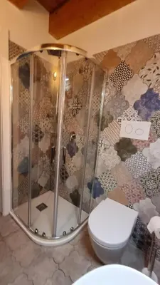a bathroom with a shower and a toilet at 2 Sicilie Rooms and Suite in Centro in Palermo