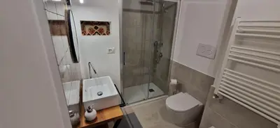 a bathroom with a shower and a toilet and a sink at 2 Sicilie Rooms and Suite in Centro in Palermo