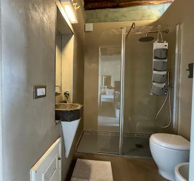 a bathroom with a shower and a toilet and a sink at A Nicuzza in Palermo