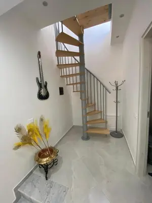 a staircase in a room with a vase and a guitar at Casa vacanza solemare in Balestrate