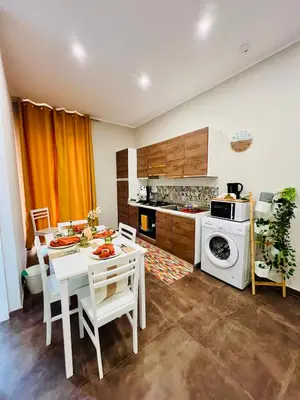 a kitchen with a white table and chairs and a stove at Marine Case Vacanze in Palermo