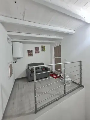a living room with a couch and a metal railing at Casetta Bella Nonna Rosetta in Mondello