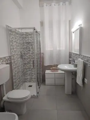 a bathroom with a shower and a toilet and a sink at GiErre Apartment in Termini Imerese