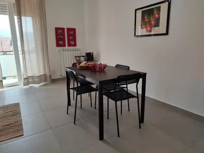 a black dining room table with black chairs in a room at GiErre Apartment in Termini Imerese