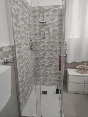 a shower with a glass door in a bathroom at GiErre Apartment in Termini Imerese