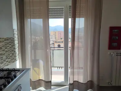 a kitchen with a window with a view of a city at GiErre Apartment in Termini Imerese