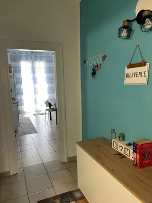 a kitchen with a blue wall and a counter top at Casa Vacanza Sicilia Dolce Mare in Balestrate