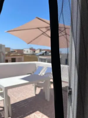 a view of a patio with a table and an umbrella at Casa Vacanza Sicilia Dolce Mare in Balestrate