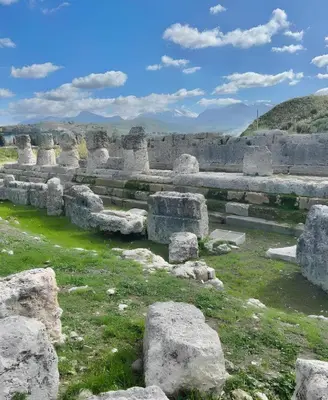 an ancient amphitheater with rocks and grass at Villa Bona in Termini Imerese