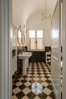 a bathroom with a sink and a checkered floor at Villa Bona in Termini Imerese