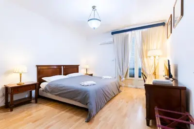 a bedroom with a large bed and a window at La Dimora del Conte, immersa nel verde in centro città in Palermo
