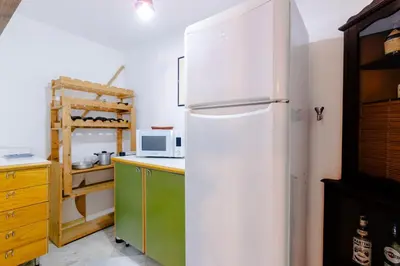 a kitchen with a white refrigerator and a microwave at La Dimora del Conte, immersa nel verde in centro città in Palermo