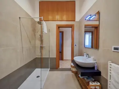 a bathroom with a sink and a glass shower at Annacati House Centro Storico in Palermo