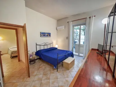 a bedroom with a bed with a blue cover at Annacati House Centro Storico in Palermo