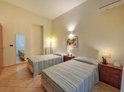 a hotel room with two beds and a hallway at Annacati House Centro Storico in Palermo