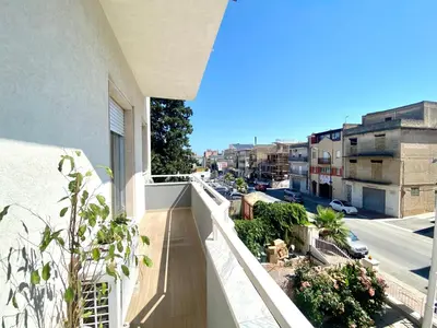 an apartment balcony with a view of a street at Alka Home, 7 km dal mare in Alcamo
