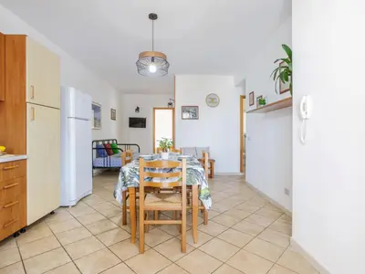 a kitchen and dining room with a table and chairs at Apartment Giardini Gaia by Interhome in San Vito lo Capo