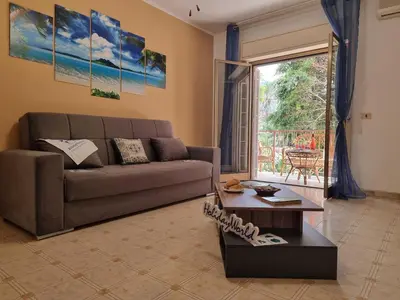 a living room with a couch and a table at Lo Scorcio sul Mare by Holiday World in Isola delle Femmine