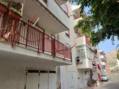 an apartment building with a balcony on a street at Lo Scorcio sul Mare by Holiday World in Isola delle Femmine