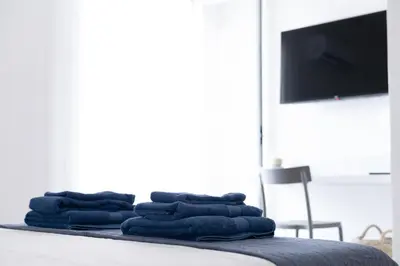 a pile of blue towels sitting on top of a bed at Casa vacanze Marinaro in Castellammare del Golfo