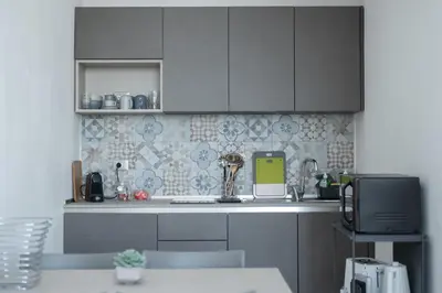 a kitchen with gray cabinets and a counter top at Casa vacanze Marinaro in Castellammare del Golfo