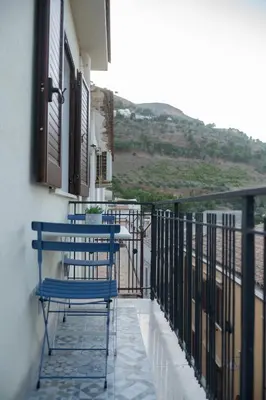 a blue chair sitting on a balcony with a view at Casa vacanze Marinaro in Castellammare del Golfo