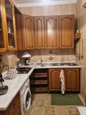 a kitchen with wooden cabinets and a sink at Blu horizon in Campofelice di Roccella