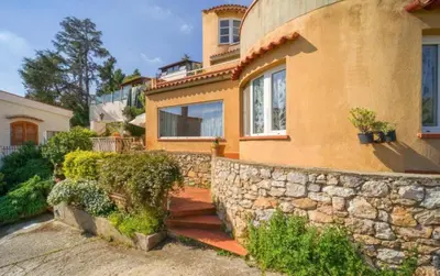 a house with a stone wall and a stone stairway at La Conca D'Oro in Palermo