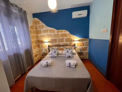 a bedroom with a bed with towels on it at Celeste Rooms in San Vito lo Capo