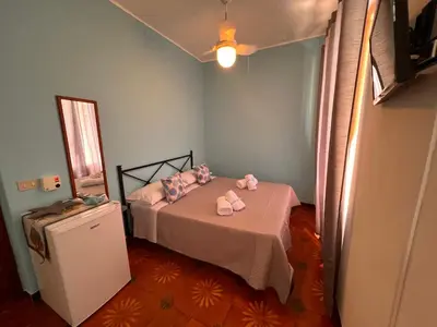 a bedroom with a bed with two stuffed animals on it at Celeste Rooms in San Vito lo Capo