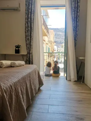 two children sitting on the floor in a bedroom with a window at Ovidio home in Palermo