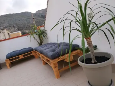 a living room with two beds and a couch at Ovidio home in Palermo