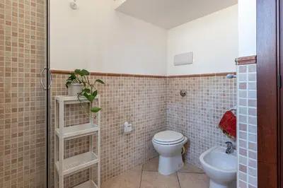 a bathroom with a toilet and a sink at The Terrace Behind the Cathedral by Wonderful Italy in Palermo
