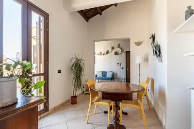 a dining room with a table and yellow chairs at The Terrace Behind the Cathedral by Wonderful Italy in Palermo