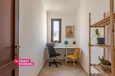 a home office with a desk and two chairs at The Terrace Behind the Cathedral by Wonderful Italy in Palermo