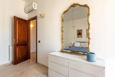 a mirror on top of a dresser in a room at The Terrace Behind the Cathedral by Wonderful Italy in Palermo