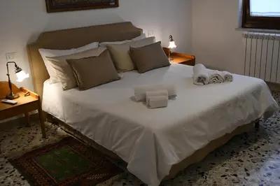 a bedroom with a large white bed with towels on it at Casa Marele in Palermo