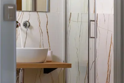 a bathroom with a white sink and a mirror at IL MARE DENTRO SUITES in San Vito lo Capo