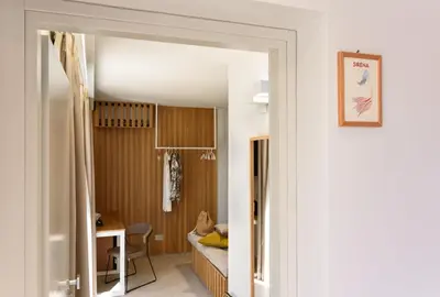 a hallway leading to a room with a bed and a desk at IL MARE DENTRO SUITES in San Vito lo Capo
