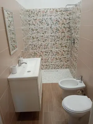 a bathroom with a sink and a toilet and a shower at Egea Casa Vacanza in Capaci