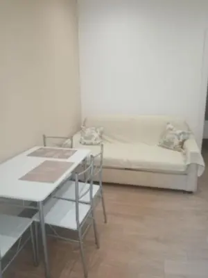 a living room with a couch and a table and chairs at Egea Casa Vacanza in Capaci