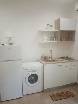 a kitchen with a washing machine and a sink at Egea Casa Vacanza in Capaci