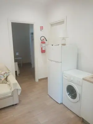 a laundry room with a washing machine and a washer at Egea Casa Vacanza in Capaci