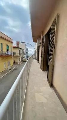 a balcony of a building with an open window at APPARTAMENTO MAESTRALE in Balestrate