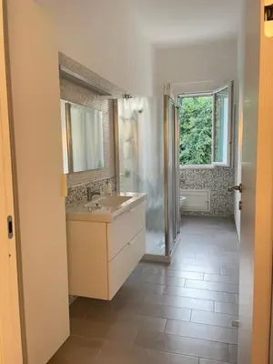 a bathroom with a sink and a mirror and a window at La Casa di Dada in Terrasini