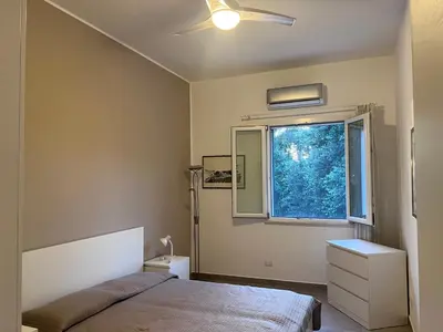 a bedroom with a bed and a window at La Casa di Dada in Terrasini
