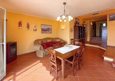 a living room with a table and a couch at Solemar Sicilia - Villa Elis in Bagheria