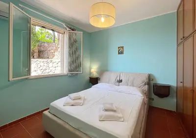 a bedroom with a bed with two towels on it at Solemar Sicilia - Villa Elis in Bagheria